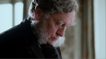 Movie still from “Mrs. Brown” (1997), directed by John Madden – An older man with a beard and a black suit; Close Up shot, Over the shoulder angle