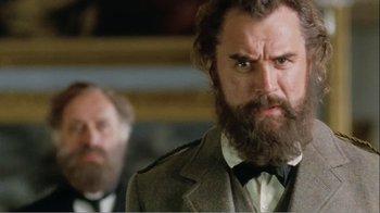Movie still from “Mrs. Brown” (1997), directed by John Madden – A man with a long beard and a suit and bow tie; Close Up shot, Low angle