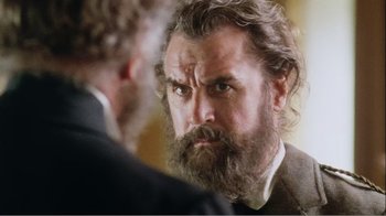 Movie still from “Mrs. Brown” (1997), directed by John Madden – A man with a long beard is talking to another man; Close Up shot, Over the shoulder angle