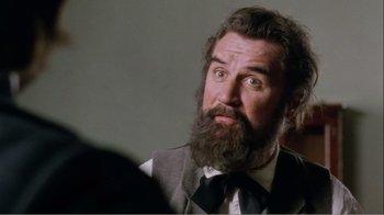 Movie still from “Mrs. Brown” (1997), directed by John Madden – A man with a long beard and a surprised look on his face; Close Up shot, Over the shoulder angle