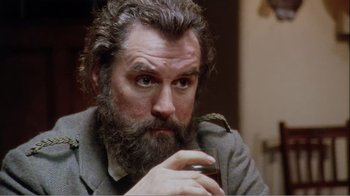 Movie still from “Mrs. Brown” (1997), directed by John Madden – A man with a beard is holding a glass of wine; Close Up shot, Low angle