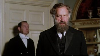 Movie still from “Mrs. Brown” (1997), directed by John Madden – A man with a long beard wearing a suit and tie; Medium shot, Low angle