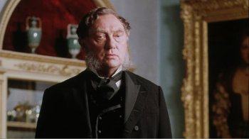 Movie still from “Mrs. Brown” (1997), directed by John Madden – An older man wearing a suit and a black tie; Close Up shot, Low angle