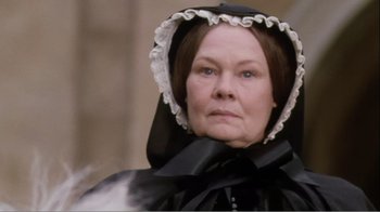 Movie still from “Mrs. Brown” (1997), directed by John Madden – An older woman wearing a black dress and a black and white hat; Close Up shot, Low angle