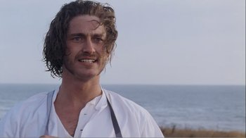 Movie still from “Mrs. Brown” (1997), directed by John Madden – A person wearing a white shirt near a body of water; Close Up shot, Over the shoulder angle