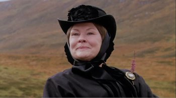 Movie still from “Mrs. Brown” (1997), directed by John Madden – An older woman wearing a black hat and a black dress; Close Up shot, Low angle