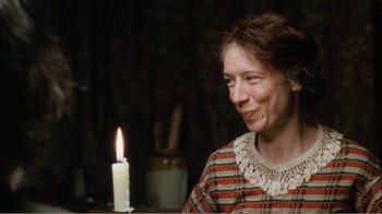 Movie still from “Mrs. Brown” (1997), directed by John Madden – An older woman sitting in front of a lit candle; Close Up shot, Over the shoulder angle