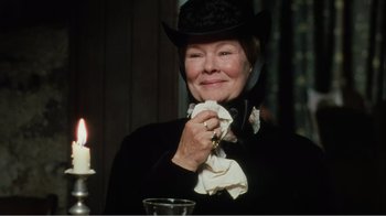Movie still from “Mrs. Brown” (1997), directed by John Madden – An older woman wearing a hat and holding a napkin; Close Up shot, Over the shoulder angle