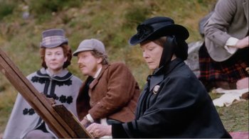 Movie still from “Mrs. Brown” (1997), directed by John Madden – A group of people sitting next to each other on top of a hill; Medium shot, High angle