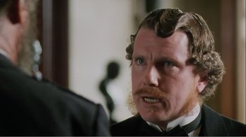 Movie still from “Mrs. Brown” (1997), directed by John Madden – A person wearing a suit and tie; Close Up shot, Over the shoulder angle