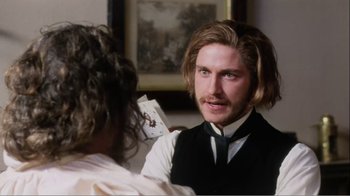 Movie still from “Mrs. Brown” (1997), directed by John Madden – A man with long blonde hair is holding a playing card; Close Up shot, Over the shoulder angle