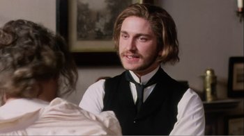 Movie still from “Mrs. Brown” (1997), directed by John Madden – A man with long brown hair wearing a black vest; Close Up shot, Over the shoulder angle