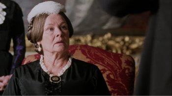 Movie still from “Mrs. Brown” (1997), directed by John Madden – An older woman wearing a white hat and a black dress; Close Up shot, Over the shoulder angle