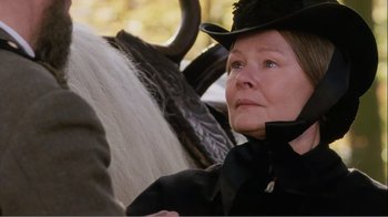 Movie still from “Mrs. Brown” (1997), directed by John Madden – A woman sitting in the back of a horse drawn carriage; Close Up shot, Low angle