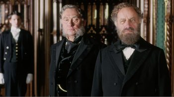 Movie still from “Mrs. Brown” (1997), directed by John Madden – A couple of men standing next to each other in a room; Medium shot, Low angle