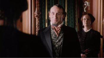 Movie still from “Mrs. Brown” (1997), directed by John Madden – A man in a suit and tie standing in front of a mirror; Close Up shot, Over the shoulder angle