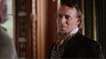 Movie still from “Mrs. Brown” (1997), directed by John Madden – A person wearing a suit and tie; Close Up shot, Over the shoulder angle