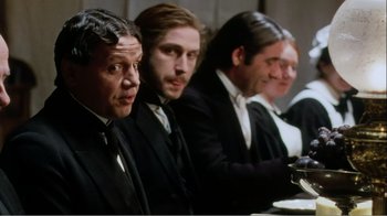 Movie still from “Mrs. Brown” (1997), directed by John Madden – A group of men in suits sitting at a dinner table; Medium shot, Over the shoulder angle