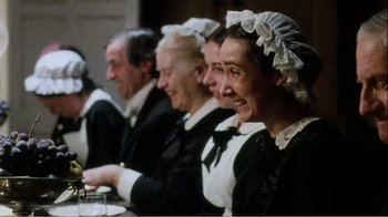 Movie still from “Mrs. Brown” (1997), directed by John Madden – A group of people sitting at a table with a plate; Medium shot, High angle