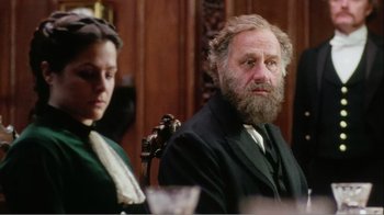 Movie still from “Mrs. Brown” (1997), directed by John Madden – An older man and a young woman sitting at a table; Medium shot, Over the shoulder angle