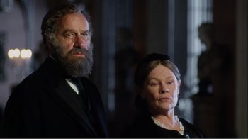 Movie still from “Mrs. Brown” (1997), directed by John Madden – An older man and a younger woman standing next to each other; Medium shot, Low angle