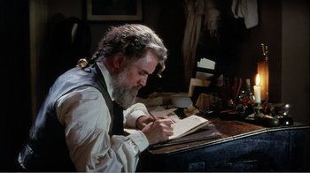 Movie still from “Mrs. Brown” (1997), directed by John Madden – An older man is writing on a notebook; Medium shot, High angle