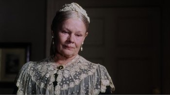 Movie still from “Mrs. Brown” (1997), directed by John Madden – An older woman wearing a white dress and a white hat; Close Up shot, Over the shoulder angle