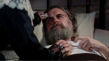 Movie still from “Mrs. Brown” (1997), directed by John Madden – An old man with a beard is getting his hair cut; Close Up shot, High angle