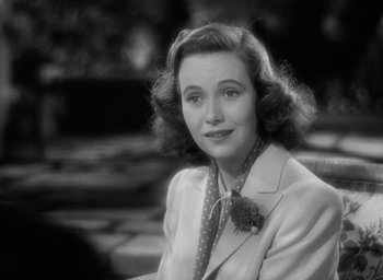Movie still from “Mrs. Miniver” (1942), directed by William Wyler – An older woman wearing a suit and tie; Close Up shot, High angle