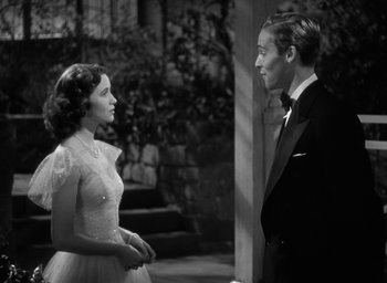 Movie still from “Mrs. Miniver” (1942), directed by William Wyler – A man and a woman standing next to each other; Medium shot, High angle