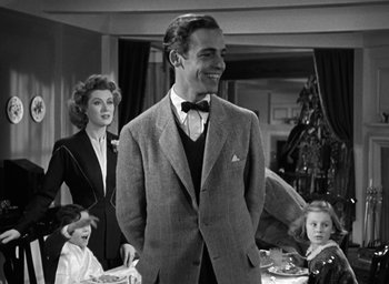 Movie still from “Mrs. Miniver” (1942), directed by William Wyler – An old photo of a man in a suit and tie; Medium shot, Low angle