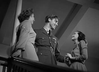 Movie still from “Mrs. Miniver” (1942), directed by William Wyler – A group of people standing next to each other on stairs; Medium shot, Low angle