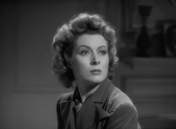 Movie still from “Mrs. Miniver” (1942), directed by William Wyler – An old photo of an older woman in a suit; Close Up shot, Low angle
