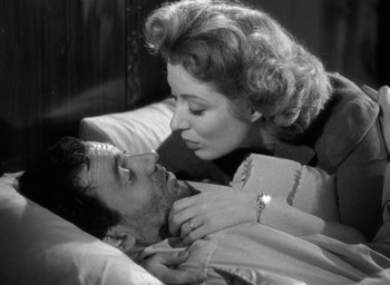 Movie still from “Mrs. Miniver” (1942), directed by William Wyler – A man and a woman laying in a bed together; Close Up shot, Low angle