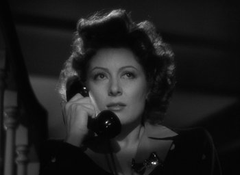 Movie still from “Mrs. Miniver” (1942), directed by William Wyler – A woman holding a phone up to her ear; Close Up shot, Low angle