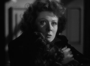 Movie still from “Mrs. Miniver” (1942), directed by William Wyler – An old photo of an old woman with long curly hair; Close Up shot, Low angle