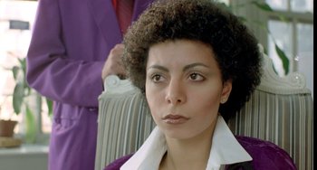 Movie still from “Ms .45” (1981), directed by Abel Ferrara – A person wearing a suit and tie; Close Up shot, Over the shoulder angle