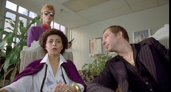 Movie still from “Ms .45” (1981), directed by Abel Ferrara – A group of people sitting in a room; Medium shot, Low angle