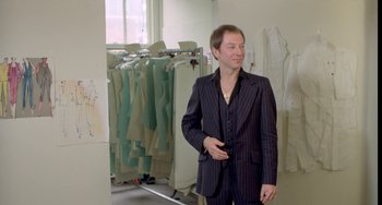 Movie still from “Ms .45” (1981), directed by Abel Ferrara – A man in a suit standing in front of a rack of clothes; Medium shot, Low angle
