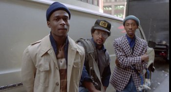 Movie still from “Ms .45” (1981), directed by Abel Ferrara – A group of men standing next to each other in a building; Medium shot, Low angle