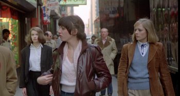 Movie still from “Ms .45” (1981), directed by Abel Ferrara – A group of people walking down a street; Medium shot, Low angle