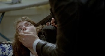 Movie still from “Ms .45” (1981), directed by Abel Ferrara – A man holding a gun over a woman's head; Close Up shot, Over the shoulder angle