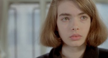 Movie still from “Ms .45” (1981), directed by Abel Ferrara – A woman's face in a black shirt; Close Up shot, Over the shoulder angle