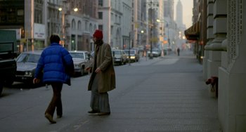 Movie still from “Ms .45” (1981), directed by Abel Ferrara – Two people walking down the street on a cold day; Wide shot, Over the shoulder angle