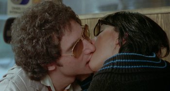 Movie still from “Ms .45” (1981), directed by Abel Ferrara – A man and a woman kissing each other on the lips; Close Up shot, Over the shoulder angle
