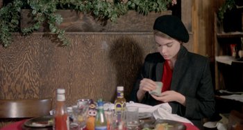 Movie still from “Ms .45” (1981), directed by Abel Ferrara – A woman sitting at a table with a cup in her hand; Medium shot, Over the shoulder angle