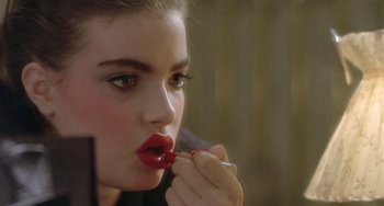 Movie still from “Ms .45” (1981), directed by Abel Ferrara – A woman putting lipstick on her lips; Close Up shot, Over the shoulder angle