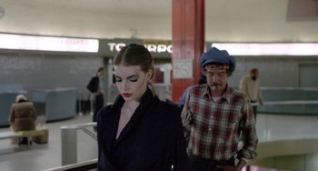 Movie still from “Ms .45” (1981), directed by Abel Ferrara – A man and a woman are walking in an airport; Medium shot, Low angle