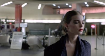 Movie still from “Ms .45” (1981), directed by Abel Ferrara – A woman in a black jacket standing next to a mirror; Close Up shot, Over the shoulder angle