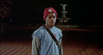 Movie still from “Ms .45” (1981), directed by Abel Ferrara – A man wearing a red hat and a blue shirt; Medium shot, Low angle